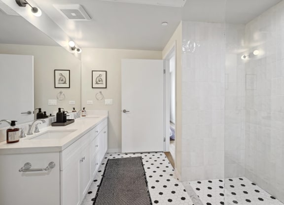 a bathroom with a shower and a sink and a rug The Baxter in Los Angeles, CA 90028