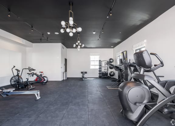 a gym with various machines and bikes in it The Baxter in Los Angeles, CA 90028