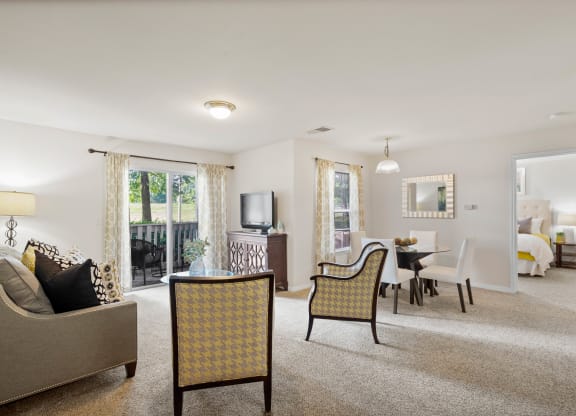 our apartments offer a living room with a fireplace and a dining area at Stonebriar Woods Apartment Homes, Overland Park, KS, 66213