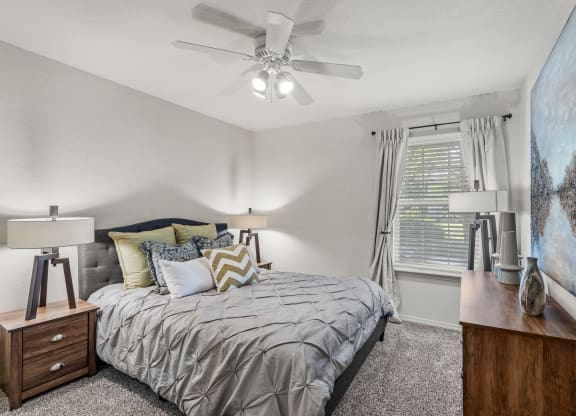 a bedroom with a bed and a ceiling fan at Pebblebrook, Overland Park, Kansas