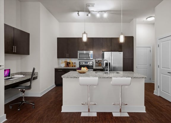 a kitchen with an island and a table with chairs
