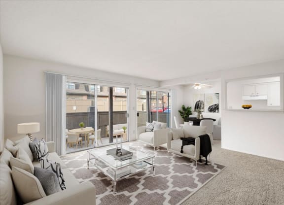 A living room with a large, open layout with a patio or balcony and lots of natural lighting.
