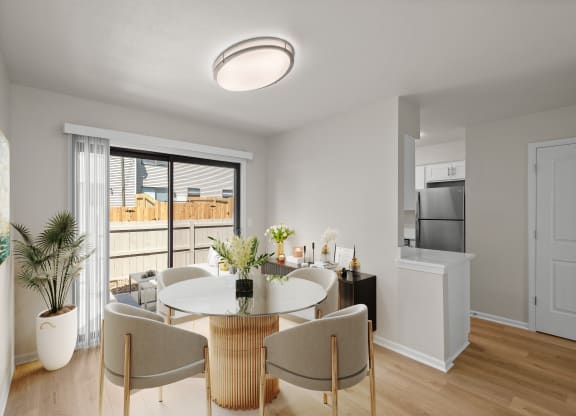 a living room and dining room with a table and chairs
