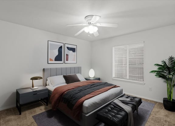 a bedroom with a bed and a ceiling fanat Millcreek Woods Apartments, Olathe, KS