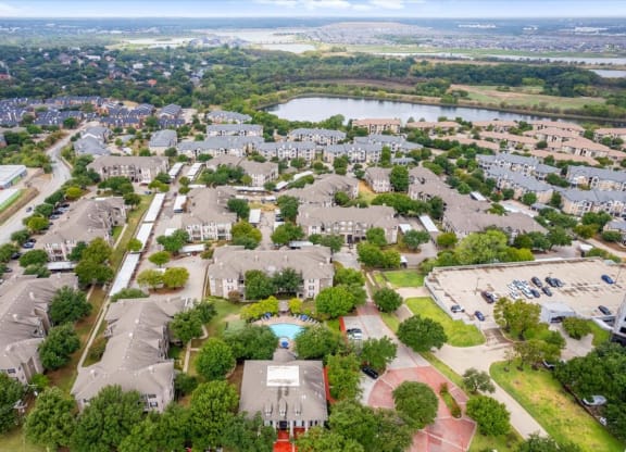 an aerial view of a neighborhood with houses at The Clairborne Apartment Homes, Grand Prairie, Texas