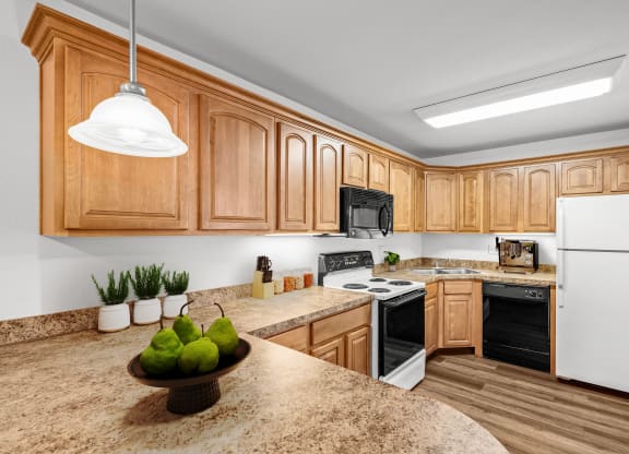 a kitchen with wooden cabinets and a granite counter top