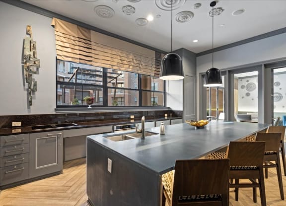 the kitchen has a large island and stainless steel appliances