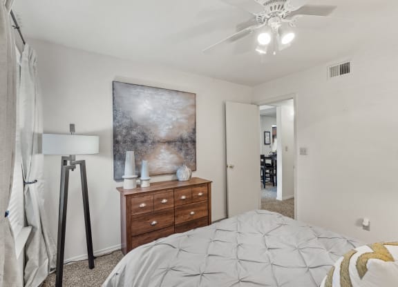 a bedroom with a bed and a dresser at Pebblebrook, Overland Park, 66212