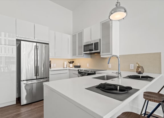a kitchen with white cabinetry and stainless steel appliances