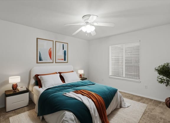 a bedroom with a bed and a ceiling fanat Millcreek Woods Apartments, Olathe, 66061