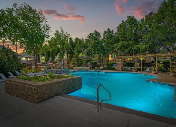 A gorgeous swimming pool with landscaping.
