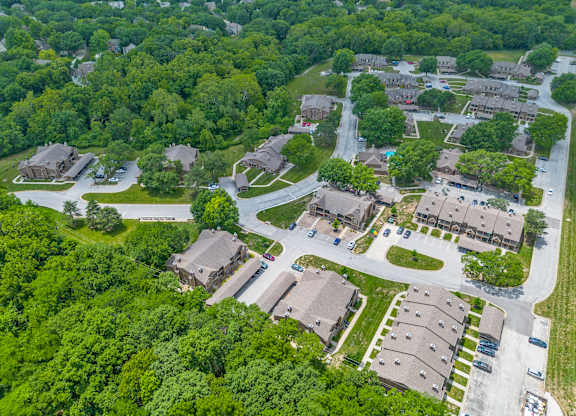 A bird's eye view of a residential area with houses and greenery.