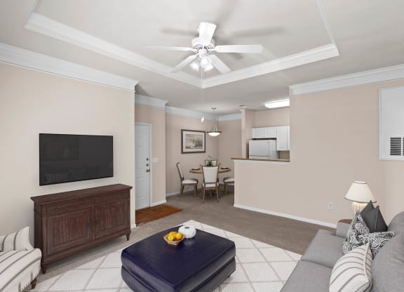a living room filled with furniture and a flat screen tv at Creekside Apartment Homes, Kansas