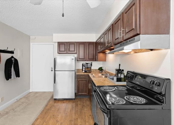 a kitchen with stainless steel appliances and wooden cabinets