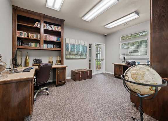 A room with a desk, chair, and bookshelf.at Crowne Chase Apartment Homes, Overland Park, KS, 66210