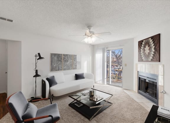 a living room with a white couch and a fireplace at Deerfield Apartments, Kansas