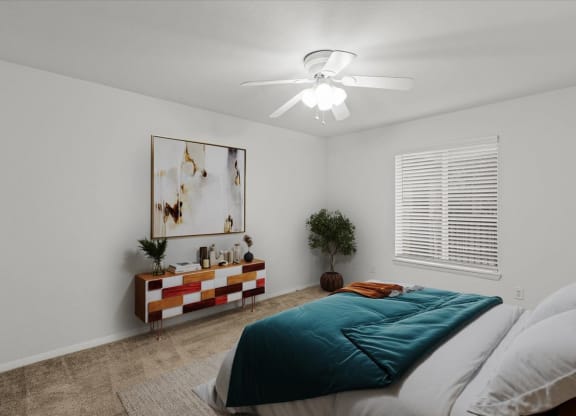 a bedroom with a bed and a ceiling fanat Millcreek Woods Apartments, Olathe, 66061