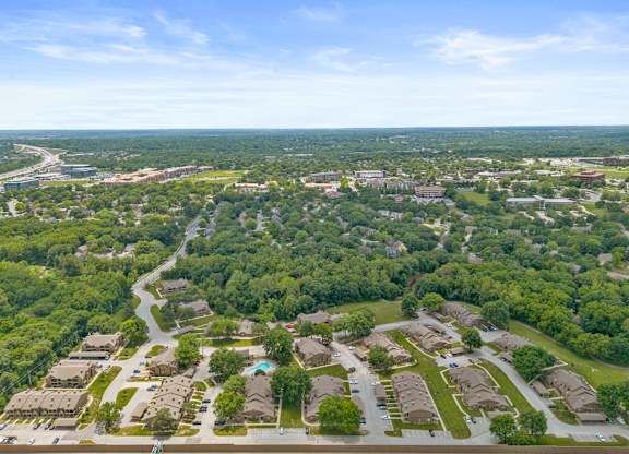 A bird's eye view of a residential area with houses and trees.