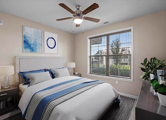 a bedroom with a large bed and a ceiling fan at The Dorset, Kansas City, Missouri