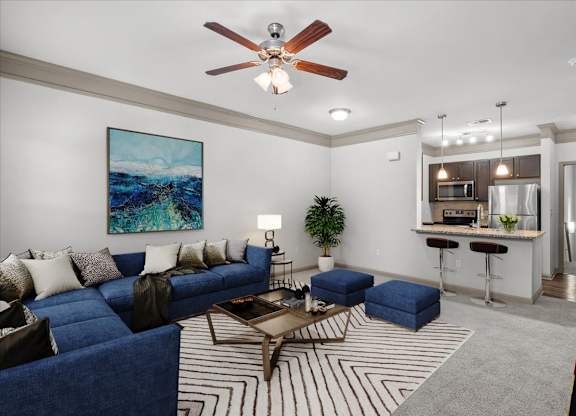 a living room with a blue couch and a coffee table at Stonepost Crossing Apartments, Kansas, 66213