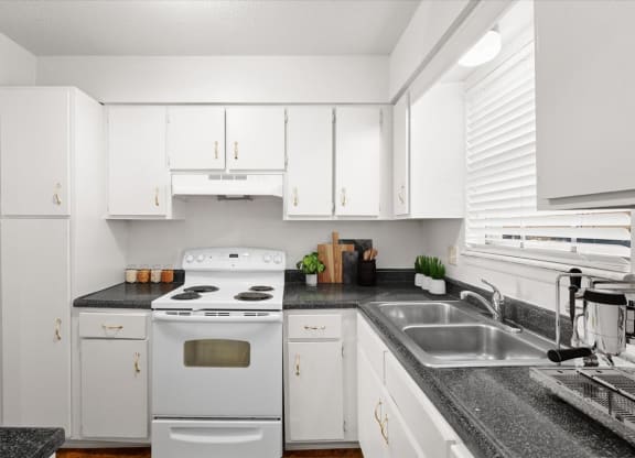 a kitchen with white appliances and white cabinets