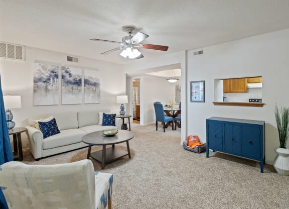 a living room with a white couch and a blue cabinet at Waterford Place Apartments & Townhomes, Kansas, 66210