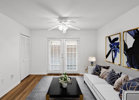 a living room with white walls and hardwood floors