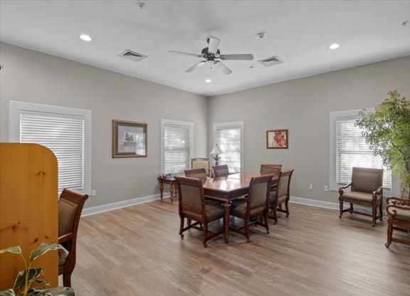 a dining room with a table and chairs and a ceiling fan