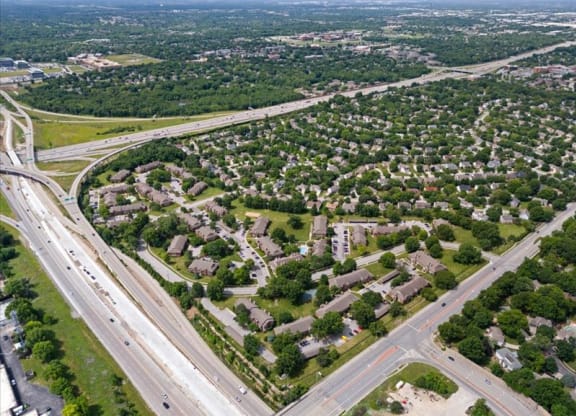 an aerial view of a city with highways and houses at Highland Park Apartment Homes, Kansas, 66214