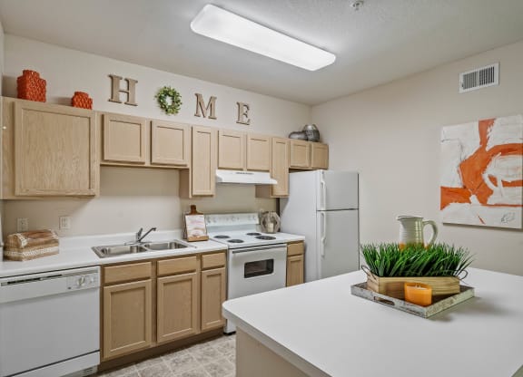 a kitchen with white appliances and wooden cabinets