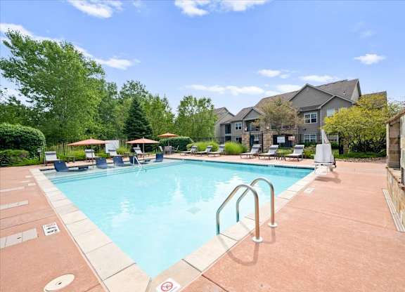 Swimming pool with lounge chairs at Stonepost Ranch Apartments, Overland Park, 66221