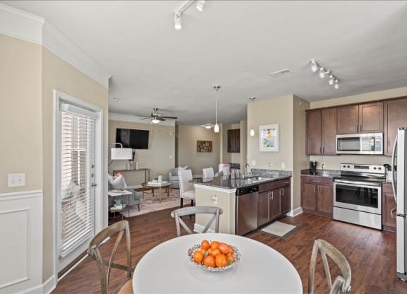 a kitchen and living room with a table and chairs at The Residences at Bluhawk Apartments, Kansas, 66085