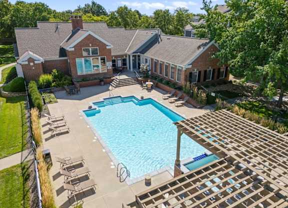 A large house with a pool in the backyard. at Somerset Oaks Apartment Homes, Olathe 66062