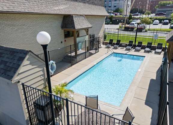 A black iron fence surrounds a small pool. at Malvern Hill Apartment Homes, Kansas