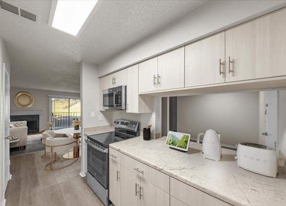 A kitchen with white appliances and cabinets.