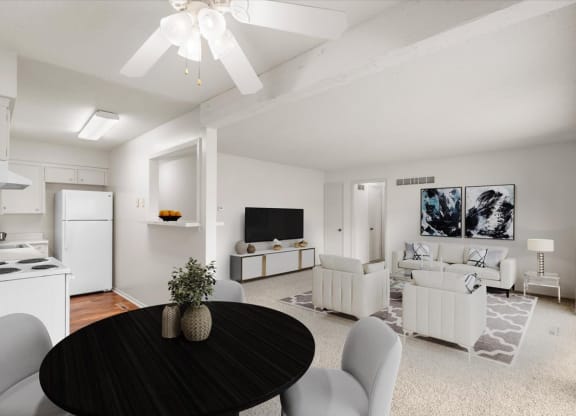 A large open layout with a ceiling fan, dining room, living area, and kitchen at a pet friendly apartment community.