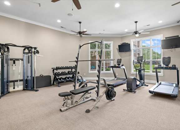 A spacious home gym with a variety of exercise equipment. at Stonepost Lakeside Apartment Homes, Olathe, 66062