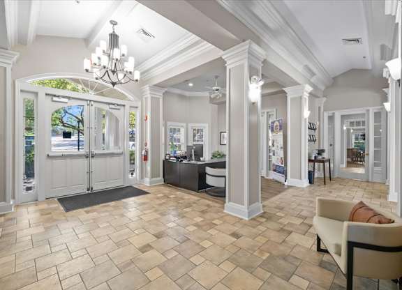 A spacious room with a tiled floor and a chandelier hanging from the ceiling. at Somerset Oaks Apartment Homes, Kansas, 66062
