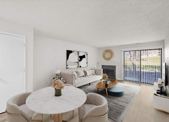 A living room with a white couch, a coffee table, and a large window.