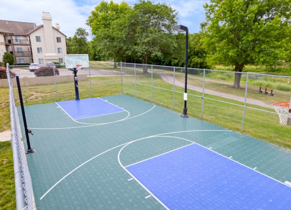 the basketball court at the whispering winds apartments in pearland, txat Millcreek Woods Apartments, Olathe