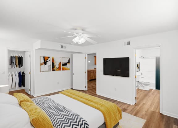 a bedroom with a bed and a ceiling fan