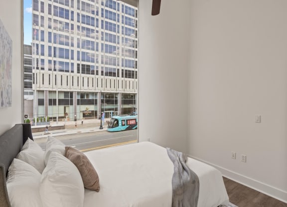 a bedroom with a large bed in front of a window