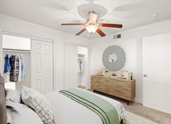 a bedroom with a ceiling fan and a closet at Fiesta Square Apartments & Townhomes, Kansas, 66212