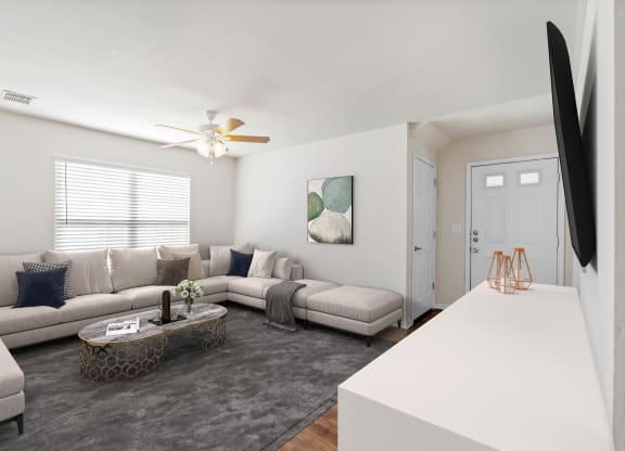 a living room with a large couch and a coffee tableat Stonebriar Woods Apartments, Overland Park