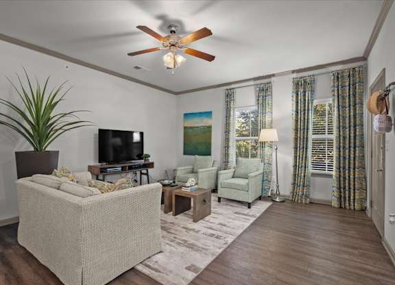 a living room with a ceiling fan and couches at Stonepost Crossing Apartments, Overland Park, KS