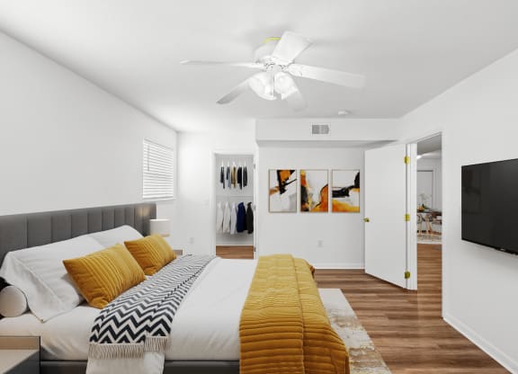 a bedroom with a large bed and a ceiling fan