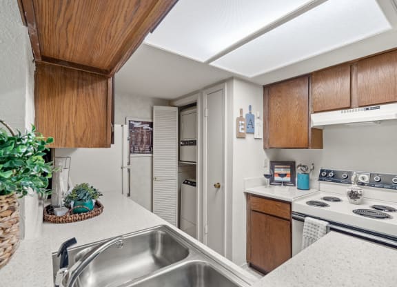 a kitchen with white countertops and a stainless steel sink at Pebblebrook, Kansas, 66212