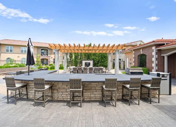 a large outdoor entertaining area with a bar and tables