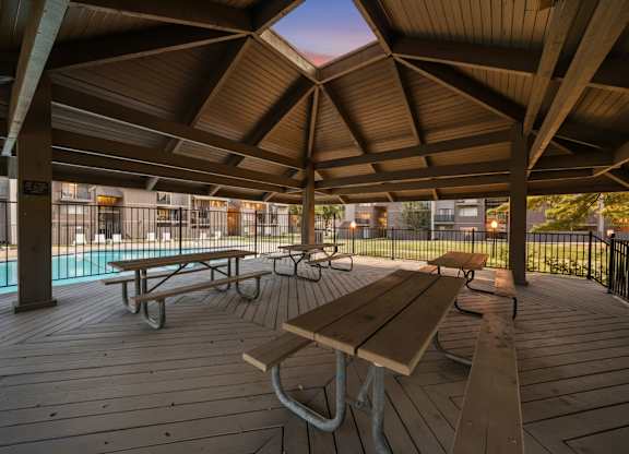 Wooden deck with picnic tables at Bremerton Park Apartment Homes , Prairie Village, KS