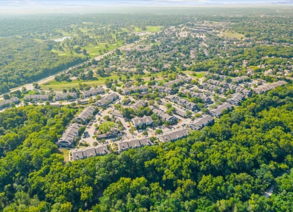 an aerial view of a neighborhood surrounded by treesat Stonebriar Woods Apartments, Overland Park, KS